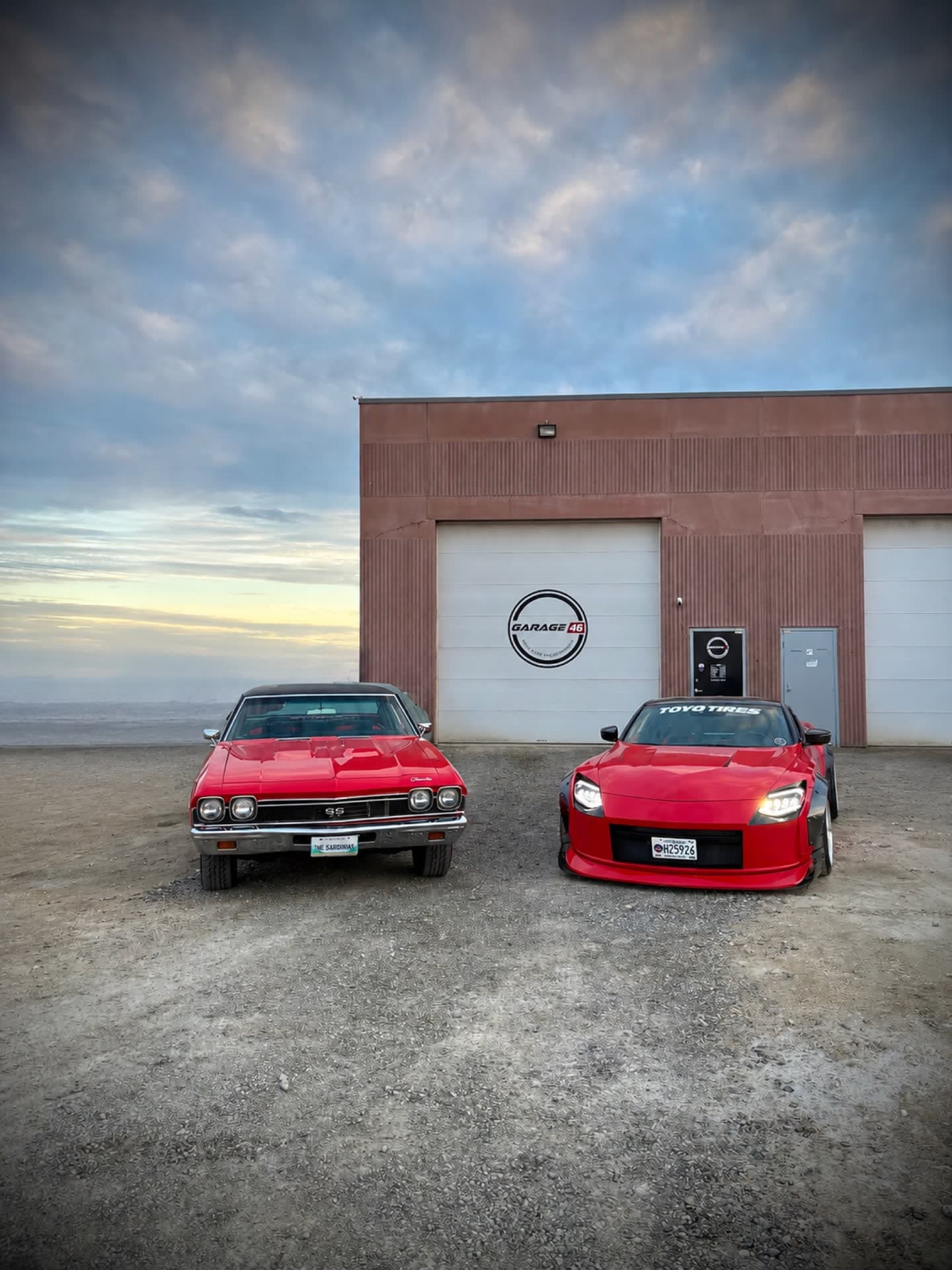The Garage 46 Z and a classic Chevelle outside the shop